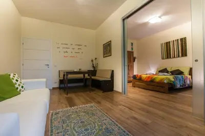 a living room with a bed and a table at Demi's home in Rome