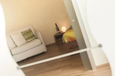a small bedroom with a bed and a chair at Demi's home in Rome