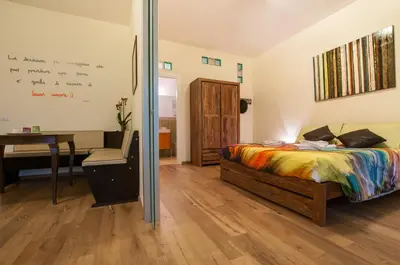 a bedroom with a bed and a desk and a table at Demi's home in Rome