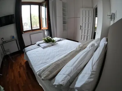 a bedroom with a large bed with a plant on it at EMI's Guest House in Rome