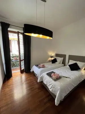 a bedroom with two beds with flowers on them at EMI's Guest House in Rome