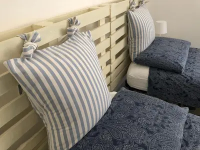 a room with two pillows and a bed and a chair at Questa casa non è un albergo CIU-ATR 9390-9 in Rome