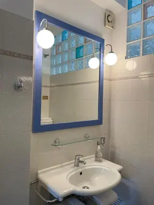 a bathroom with a sink and a mirror at Questa casa non è un albergo CIU-ATR 9390-9 in Rome