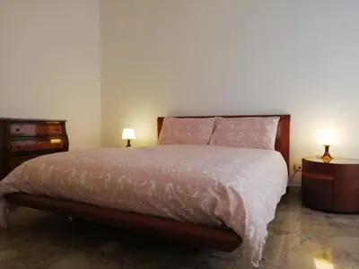 a bedroom with a bed and two lamps on tables at Questa casa non è un albergo CIU-ATR 9390-9 in Rome
