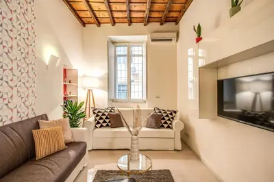 a living room with a couch and a tv at FRESH HOUSE CAVOUR in Rome