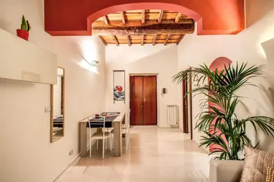 a hallway of a house with a table and a plant at FRESH HOUSE CAVOUR in Rome