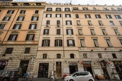 a large building with cars parked in front of it at FRESH HOUSE CAVOUR in Rome