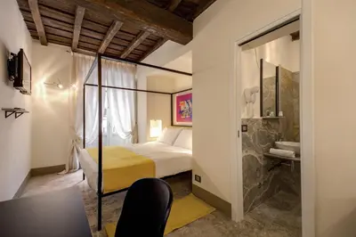 a hotel room with a bed and a bathroom at Residenze Argileto in Rome