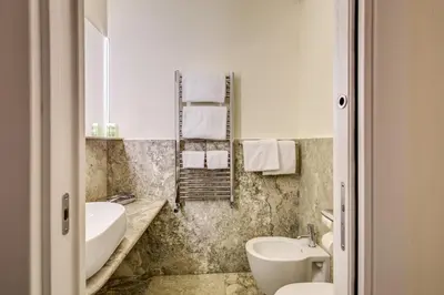 a bathroom with a sink and a tub and a toilet at Residenze Argileto in Rome