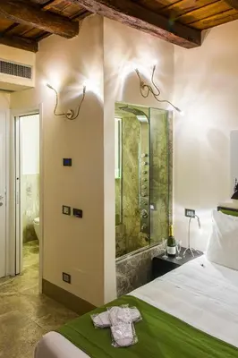 a bathroom with a shower and a bed in a room at Residenze Argileto in Rome