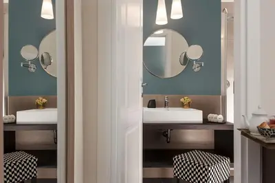 a bathroom with two sinks and two mirrors at Charme 308 in Rome