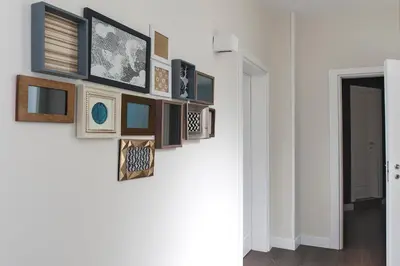 a gallery wall with framed pictures on a wall at Charme 308 in Rome