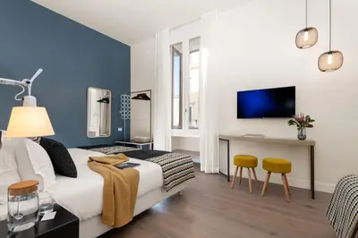 a bedroom with a bed and a desk and a tv at Charme 308 in Rome