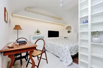 a bedroom with a bed and a desk and a table at Relax Chiavari House in Rome