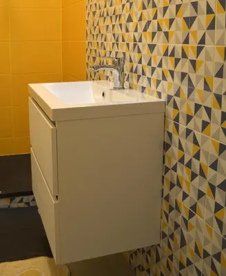 a bathroom with a white sink and a mosaic wall at Sophie's Choice 2 a San Pietro in Rome