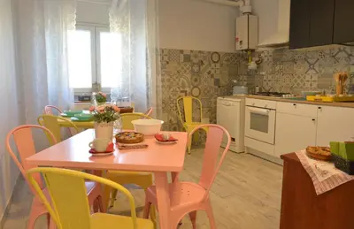 a kitchen and dining room with a table and chairs at Sophie's Choice 2 a San Pietro in Rome