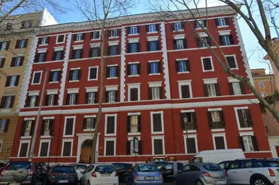 a red building with cars parked in front of it at Sophie's Choice 2 a San Pietro in Rome