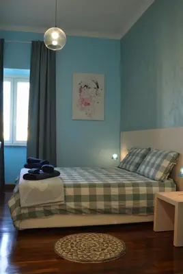 a bedroom with a bed with blue walls at Sophie's Choice 2 a San Pietro in Rome