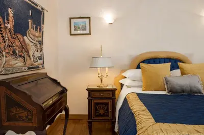 a bedroom with two beds and a table with a lamp at Luxury Apt with Colosseum View in Rome