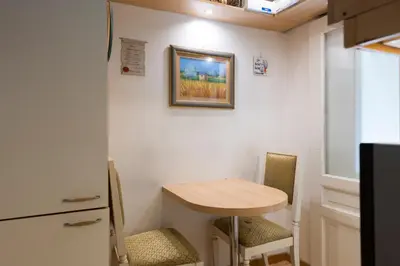 a small kitchen with a small table and two chairs at Luxury Apt with Colosseum View in Rome