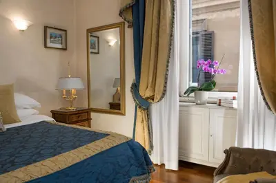 a bedroom with a blue bed and a window at Luxury Apt with Colosseum View in Rome