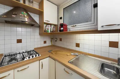 a kitchen with a sink and a stove at Luxury Apt with Colosseum View in Rome