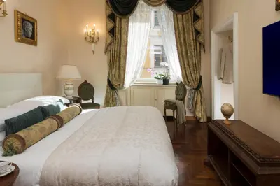 a bedroom with a large bed and a window at Luxury Apt with Colosseum View in Rome