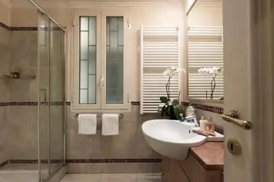 a bathroom with a sink and a shower at Luxury Apt with Colosseum View in Rome