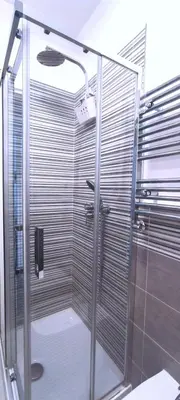 a shower with a glass door in a bathroom at Casa Giustiniano - Metro San Paolo in Rome