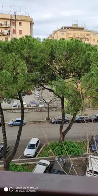 a parking lot with cars parked in a parking lot with trees at Casa Giustiniano - Metro San Paolo in Rome