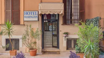 a hotel building with a door with plants in front of it at Hotel Washington in Rome