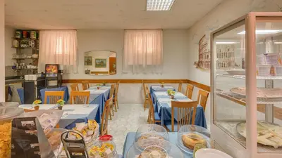 a dining room with blue tables and chairs at Hotel Washington in Rome