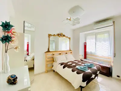 a bedroom with a large bed and a mirror at Vatican Town House in Rome