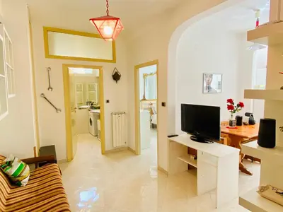 a living room with a couch and a television at Vatican Town House in Rome