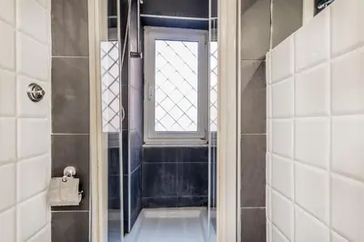 a bathroom with a shower and a window at BBHOME Comfort apartment near Colosseum in Rome