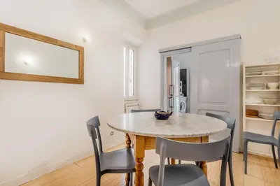 a kitchen and dining room with a table and chairs at BBHOME Comfort apartment near Colosseum in Rome