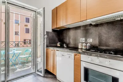 a kitchen with a white stove top oven next to a window at BBHOME Comfort apartment near Colosseum in Rome