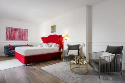 a bedroom with a red bed and a chair at Monastero dei Santi in Rome