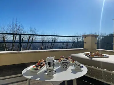 a table with two plates of food on a balcony at Monastero dei Santi in Rome