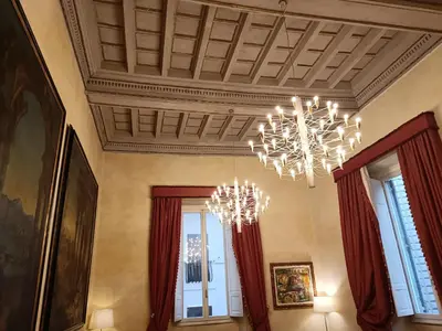 a living room with a chandelier and windows at Residenza al Pantheon - RH Collection in Rome