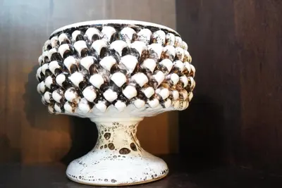 a white vase with a bunch of spheres on it at Residenza al Pantheon - RH Collection in Rome