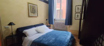 a bedroom with a blue bed and a window at Residenza al Pantheon - RH Collection in Rome