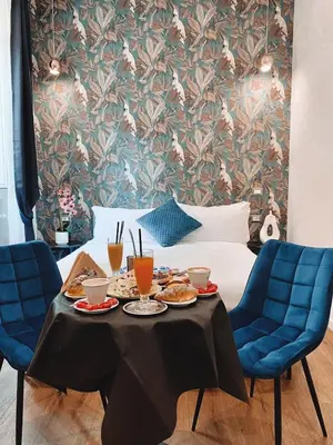 a table with food on it with two blue chairs at The Venue Sistina in Rome
