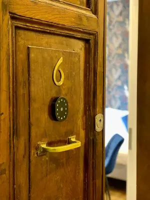 a wooden door with a lock on it at The Venue Sistina in Rome