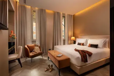 a hotel room with a bed and a chair at Hotel La Place Roma in Rome