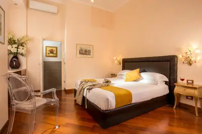 a bedroom with a bed and a chair in it at Flaminia Charme in Rome