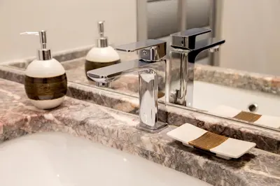 a bathroom sink with a faucet and a mirror at Flaminia Charme in Rome