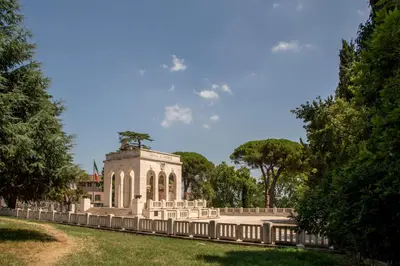 a building in the middle of a park with trees at Daplace - Terenzia Apartment in Rome