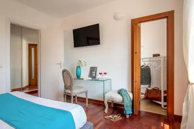 a bedroom with a bed and a desk with a chair at Daplace - Terenzia Apartment in Rome