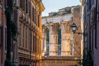 a building with a column in the middle of a street at Daplace - Flaminia Apartment in Rome